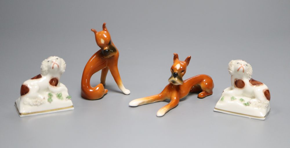 A pair of Goebel ceramic Dobermans, tallest 7.5cm and a pair of miniature Continental Spaniels, 5cm high